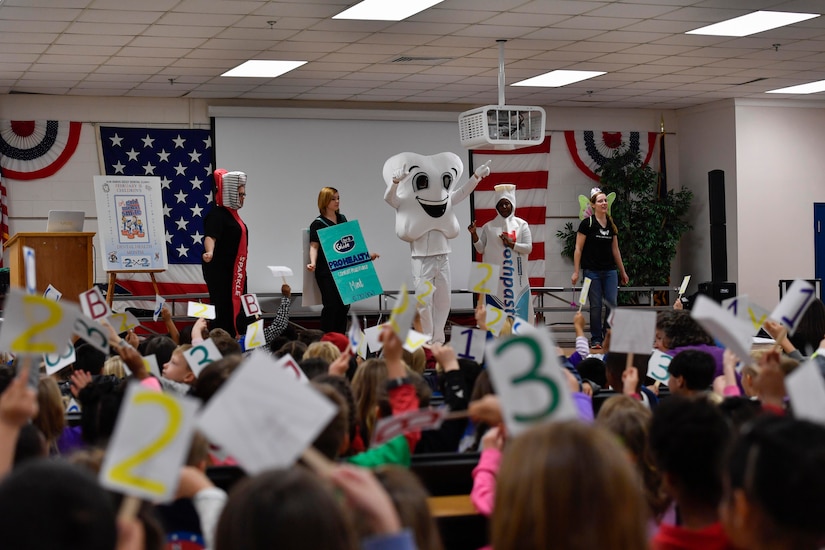 Members of the 628th Medical Group Dental Health Clinic sing a song about dental hygiene to students during a National Children’s Dental Health Month outreach event at Marrington Elementary School, Feb. 10, 2017. Establishing a good dental routine and going to the dentist regularly at an early age can help children develop life-long habits for healthy teeth and gums. The dental clinic will reach out to the Child Development Center, youth center and other schools throughout the month of February to educate children on dental health.