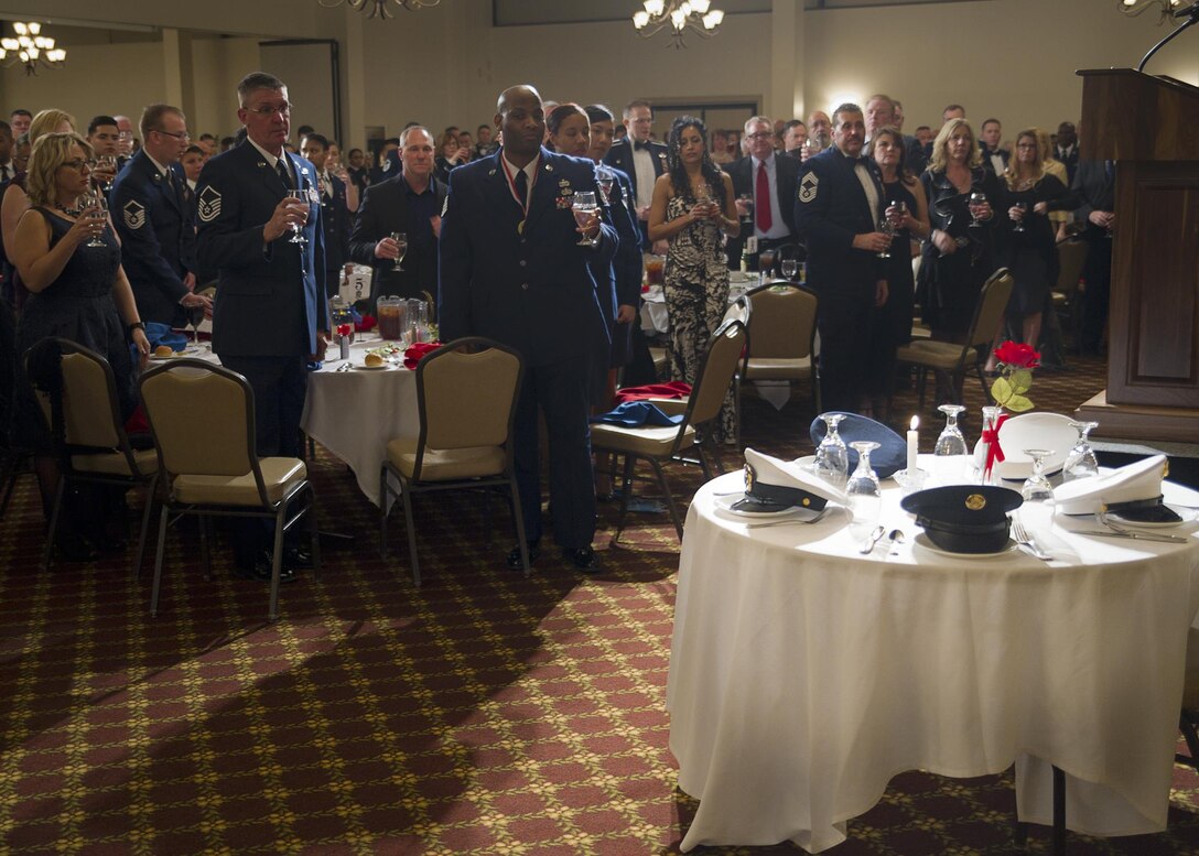 Airmen toast service members who have passed away during the Table of Honor Ceremony at the wing's annual awards banquet Feb 11. The ceremony recognizes military members who have paid the ultimate sacrifice.