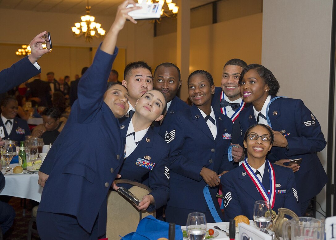 Airmen pose for a selfie during the wing's annual awards banquet at Tommy B's Activity Center Feb 11.