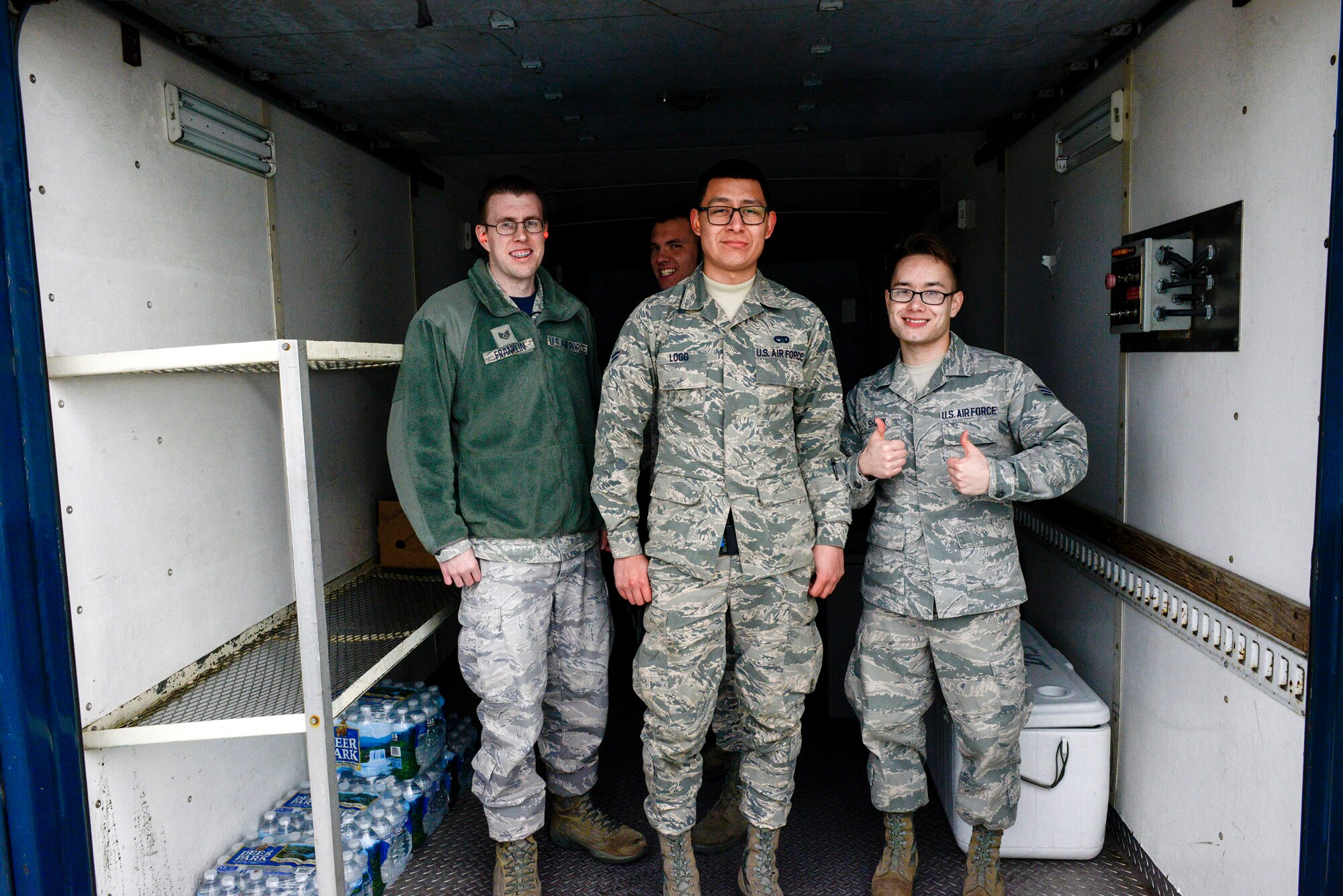 89th Aerial Port Squadron fleet services agents Staff Sgt. Gregory Franklin, Airman 1st Class Theron Logg and Senior Airman Joseph Shank, pose for a photo after loading food onto a C-40B at from Joint Base Andrews, Maryland, Feb. 3, 2017. Members of the 89th APS, often called ‘the Port Dawgs,’ were recently recognized with winning the Air Force Large Terminal of the Year award for providing around-the-clock air transportation support for the president, national leaders, combatant commanders and Special Air Mission operations. 