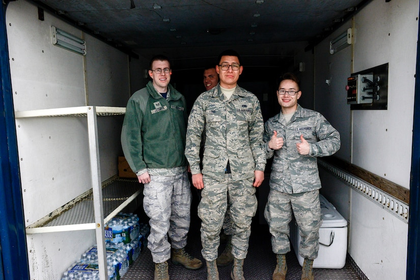 89th Aerial Port Squadron fleet services agents Staff Sgt. Gregory Franklin, Airman 1st Class Theron Logg and Senior Airman Joseph Shank, pose for a photo after loading food onto a C-40B at from Joint Base Andrews, Maryland, Feb. 3, 2017. Members of the 89th APS, often called ‘the Port Dawgs,’ were recently recognized with winning the Air Force Large Terminal of the Year award for providing around-the-clock air transportation support for the president, national leaders, combatant commanders and Special Air Mission operations. 