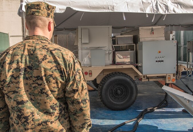 Lt. Col. William P. Dobbins, an engineer for U.S. Marine Corps Forces Command, watches a demonstration and test kickoff of the first logistics fuel (JP-8) compatible renewable-hybrid Solid Oxide Fuel Cell (SOFC) system Jan. 26, 2017, at Naval Surface Warfare Center, Carderock Division in West Bethesda, Md. (U.S. Navy photo by Jake Cirksena/Released)