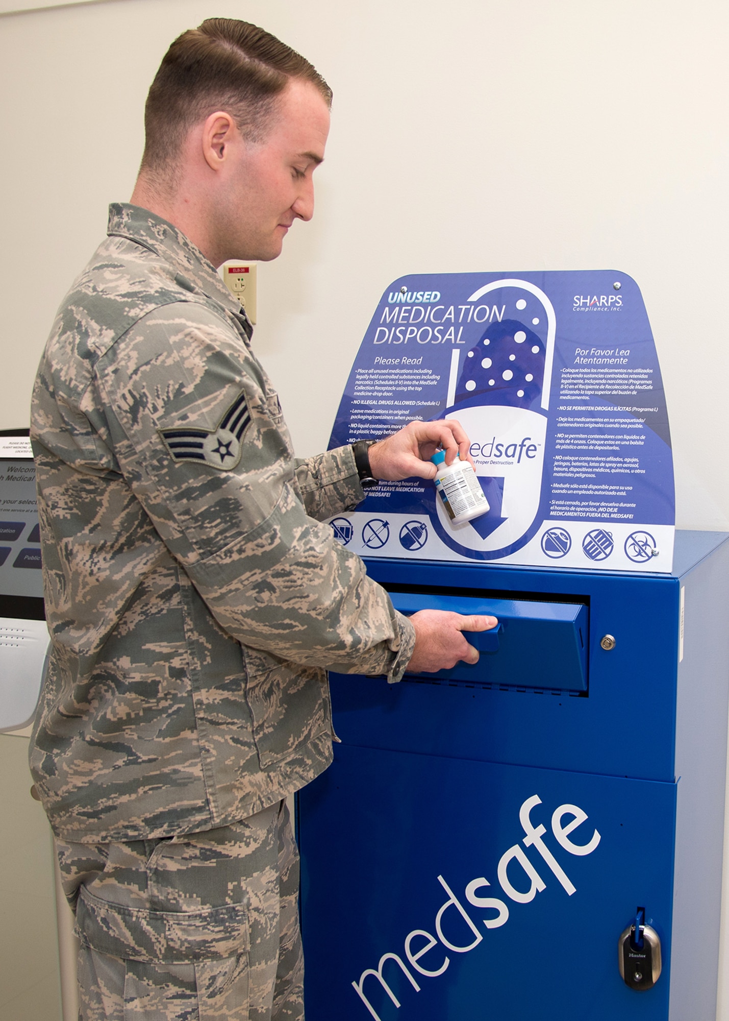 Senior Airman Matthew Marra, 66th Medical Squadron pharmacy technician, discards medication in a MedSafe container in the lobby of the clinic last month. Personnel with base access may now safely turn in unused or expired medication at the MedSafe drop box Monday through Friday from 7:30 a.m. to 4:30 p.m. (U.S. Air Force photo by Mark Herlihy)