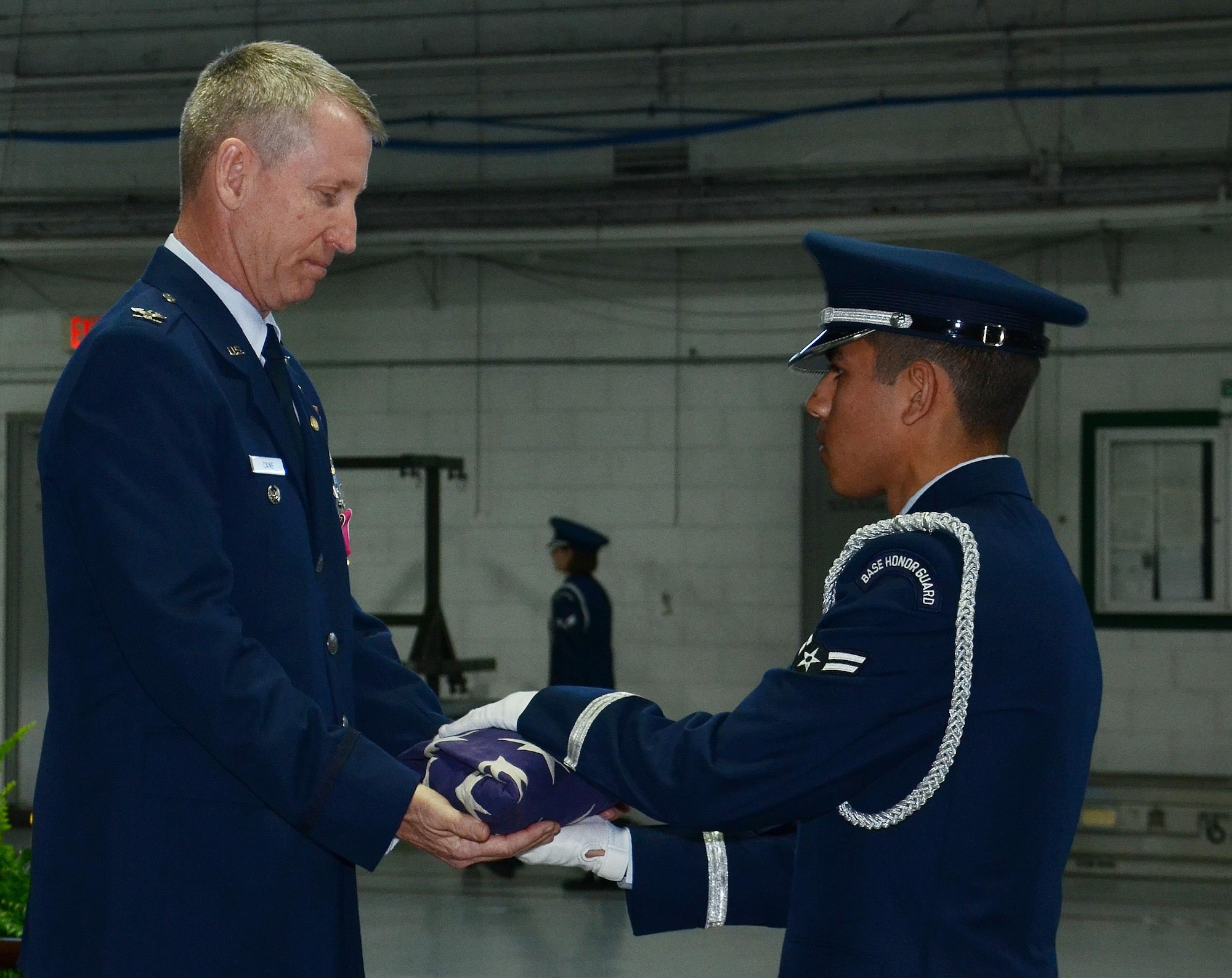 U.S. Air Force Col. Scott Caine, 9th Air Force vice commander, receives a folded American Flag from Airman 1st Class Michael De La Cruz, Shaw Air Force Base Honor Guard ceremonial guardsman, during Caine’s retirement ceremony, Shaw AFB, S.C., Feb. 10, 2017. As part of the ceremony, the American Flag was displayed and refolded to show respect and gratitude toward those who have fought and continue to fight for freedom. (U.S. Air Force photo by Tech. Sgt. Amanda Dick)