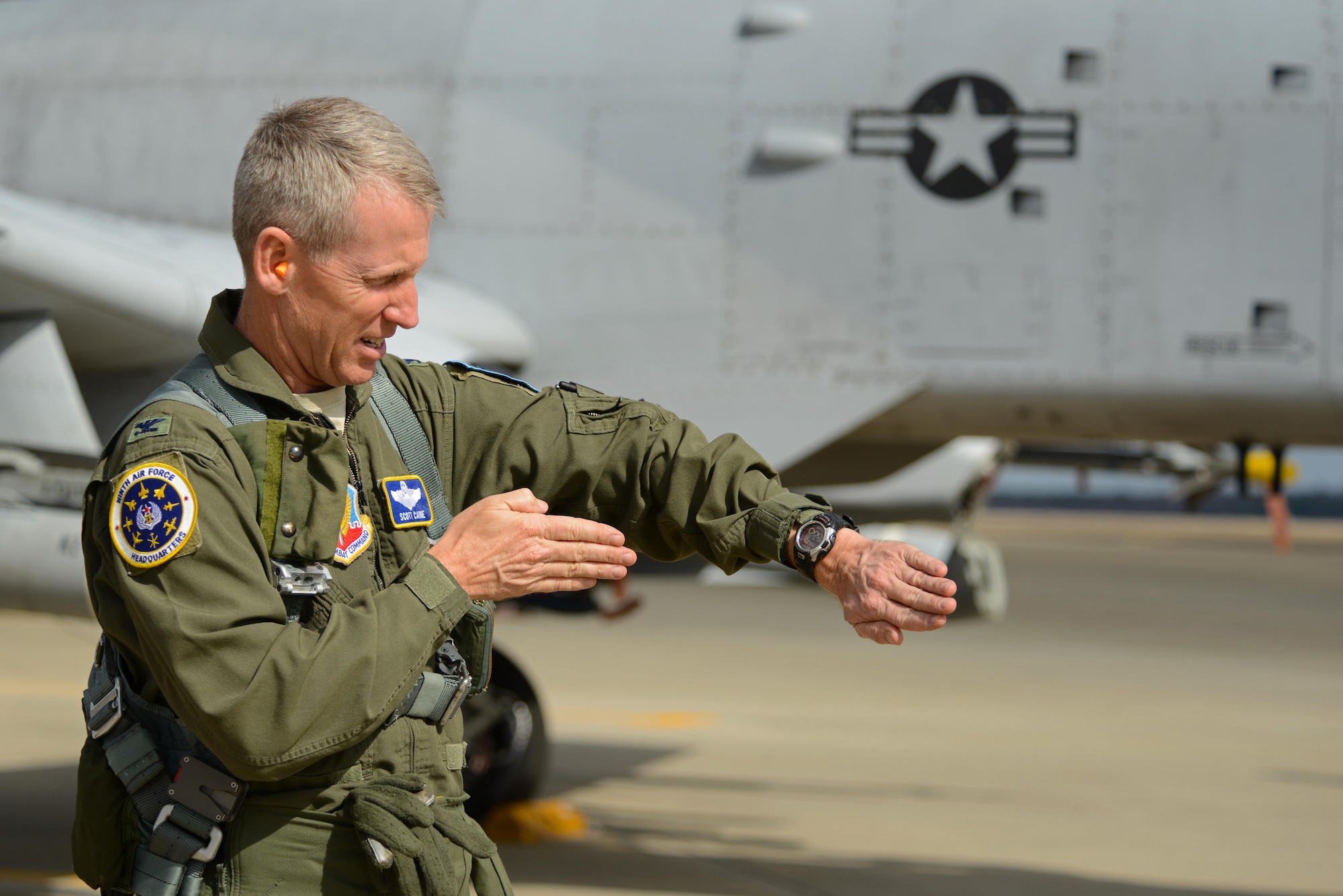 U.S. Air Force Col. Scott Caine, 9th Air Force vice commander, gestures toward his watch before completing his final flight in the Air Force, Shaw Air Force Base, S.C., Feb. 8, 2017. Caine piloted an A-10C Thunderbolt II for his final flight before retiring after 30 years of service. (U.S. Air Force photo by Airman 1st Class Kathryn R.C. Reaves)