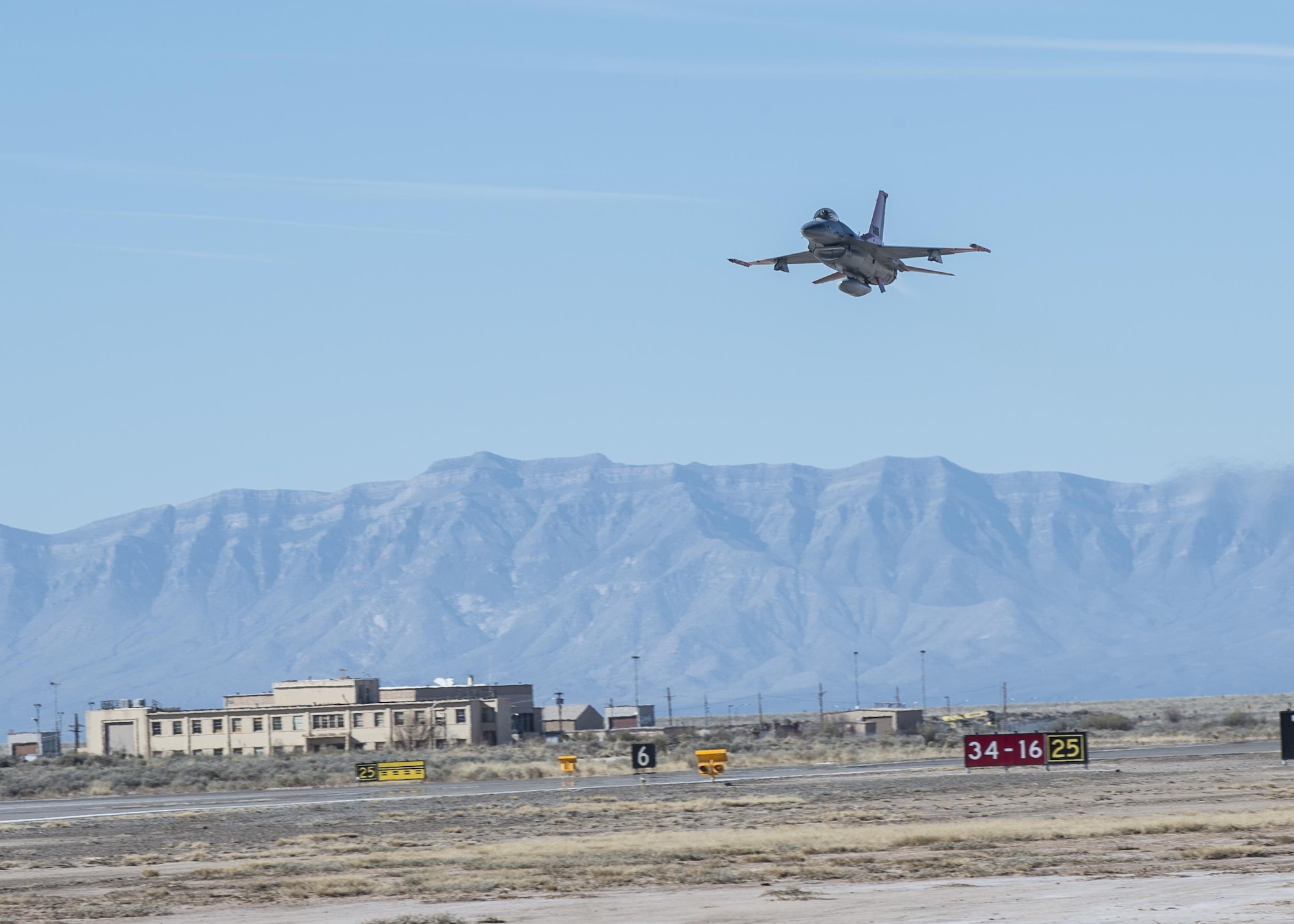 A QF-16 drone flies over Holloman Air Force Base, N.M., on Feb. 10, 2017. Lt. Col. Ronald King, the 82nd Aerial Targets Squadron, Det. 1 commander, piloted the drone during the first flight at Holloman since the transition from QF-4 Phantoms to QF-16s. The QF-16 serves as a full-scale aerial target to test next-generation weapons systems. (U.S. Air Force photo by Senior Airman Emily Kenney)