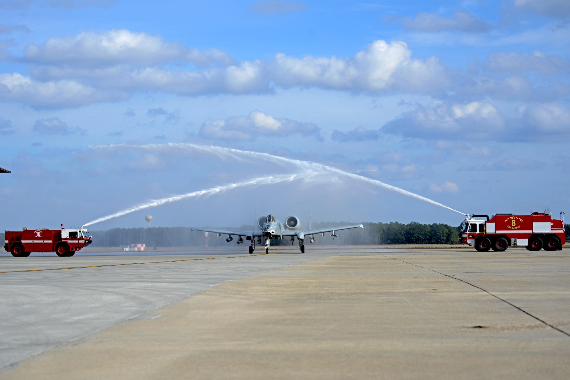 U.S. Air Force Col. Scott Caine, 9th Air Force vice commander, taxies an A-10C Thunderbolt II between fire trucks during his final flight, Shaw Air Force Base, S.C., Feb. 8, 2017. Taxiing an aircraft through fire truck hoses is a tradition for Air Force pilots following their final flight. (U.S. Air Force photo by Airman 1st Class Kathryn R.C. Reaves)