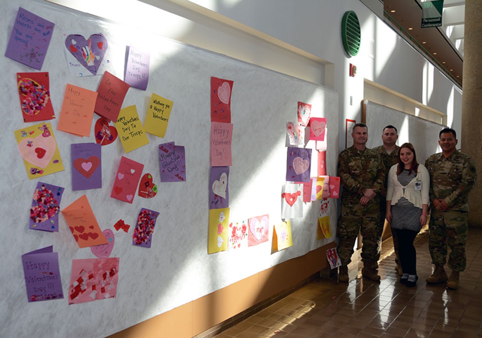 Defense Logistics Agency Aviation military members Chief Warrant Officer 4 Kevin Ryan, Chief Warrant Officer 3 Michael Jackson and Army Maj. Alex Shimabukuro from Defense Supply Center Richmond hung valentines cards, made by children at the Betty Ackerman-Cobb Child Development Center on DSCR, along the walls from the atrium for veterans to enjoy with Anne McLaughlin from Voluntary Service Feb. 10 2017 at Hunter Holmes McGuire Veterans Administration Medical Center. The valentines for veterans will be on display through the month in support to the Veterans Administration’s annual Salute to Veterans. 