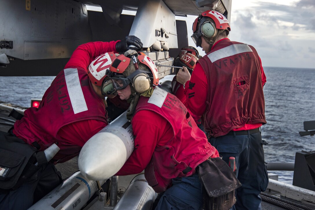 Sailors load a missile onto an F/A-18E Super Hornet aircraft on the flight deck aboard the aircraft carrier USS Carl Vinson in the Pacific Ocean, Feb. 7, 2017. Navy photo by Seaman Jake Cannady