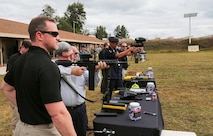 USCENTCOM and USSOCOM hosted a familiarization fire (FAMFIRE) demonstration of non-lethal weapons. During the event, attendees had the opportunity to use some of the weapons and fire them in a controlled environment. Here a variety of pepperball and paintball non-lethal munitions are fired.
