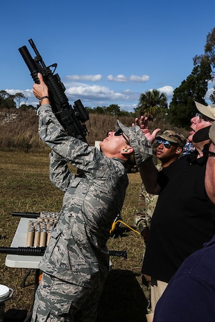 Colonel April Vogel, Commander, 6th Air Mobility Wing, MacDill Air Force Base fires a 40MM Red White Blue Hail and Warning Round.

The event was to familiarize and demonstrate the capabilities of non-lethal munitions. During the event, attendees had the option to use some of the weapons and fire them in a controlled environment.
