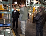 Christopher Camacho, Area Manager, DLA Disposition Services (left); and U.S. Air Force Lt. Gen. Andrew E. Busch, director, Defense Logistics Agency; look at damaged doors taken from High Mobility Multipurpose Wheeled Vehicles, aka Humvees, as Busch tours a DLA warehouse with Joseph Hayward, Supply Management Specialist, DLA Distribution and Brent Cox, Director, DLA Distribution aboard Marine Corps Logistics Base Barstow Jan. 26.