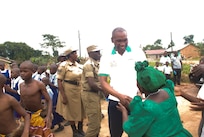 Maj. Frank Musisi, center, visits the medical clinic he founded in Uganda, the Ssese Islands African Aids Project (SIAAP), in 2015. 