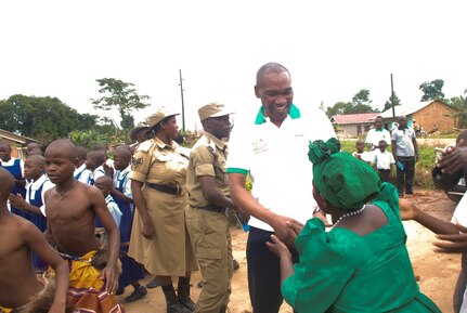 Maj. Frank Musisi, center, visits the medical clinic he founded in Uganda, the Ssese Islands African Aids Project (SIAAP), in 2015. 