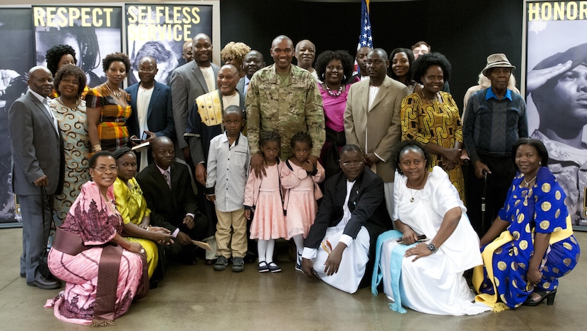 Maj. Frank Musisi, center, celebrates his promotion from captain to major with family and friends Oct. 14, 2016, at Joint Forces Training Base Los Alamitos, Calif..