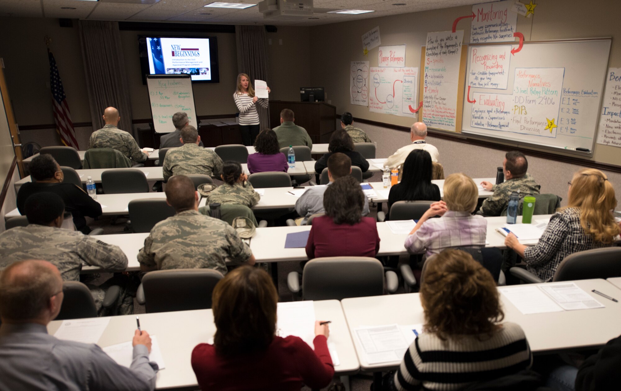 PETERSON AIR FORCE BASE, Colo. – Laura Rolfe, 21st Force Support Squadron civilian personnel flight employee relations specialist, trains supervisors on the new Department of Defense Performance Management and Appraisal Program at Peterson Air Force Base, Colo., Feb. 7, 2017. Rolfe took a binder packed with hundreds of information-filled pages and consolidated the meat of the training into a two-and-a-half hour, time-efficient instruction. (U.S. Air Force photo by Airman 1st Class Dennis Hoffman)