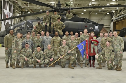 Soldiers assigned to Charlie Company, 4th Attack Reconnaissance Battalion, 2nd Aviation Regiment pose for a picture with Eighth Army Commanding General, Lt. Gen. Thomas S. Vandal and Eighth Army Senior Enlisted Advisor, Command Sgt. Maj. Richard E. Merritt at the conclusion of an Eighth Army Readiness Streamer ceremony at Camp Humphreys, Pyeongtaek, South Korea, Feb. 9. During the event, Vandal recognized Charlie Company for maintaining high levels of physical, mental and tactical readiness in the last 180 days.