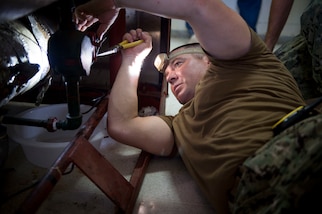 PUERTO BARRIOS, Guatemala (Feb. 8, 2017) - Construction Electrician 2nd Class Charles King, a native of Huntington Beach, Calif., assigned to Construction Battalion Mobile Unit (CBMU) 202, performs maintenance on a surgical equipment sterilization unit during a visit to a hospital in Puerto Barrios, Guatemala, in support of Continuing Promise 2017 (CP-17). CP-17 is a U.S. Southern Command-sponsored and U.S. Naval Forces Southern Command/U.S. 4th Fleet-conducted deployment to conduct civil-military operations including humanitarian assistance, training engagements, and medical, dental, and veterinary support in an effort to show U.S. support and commitment to Central and South America. (U.S. Navy photo by Mass Communication Specialist 2nd Class Shamira Purifoy)