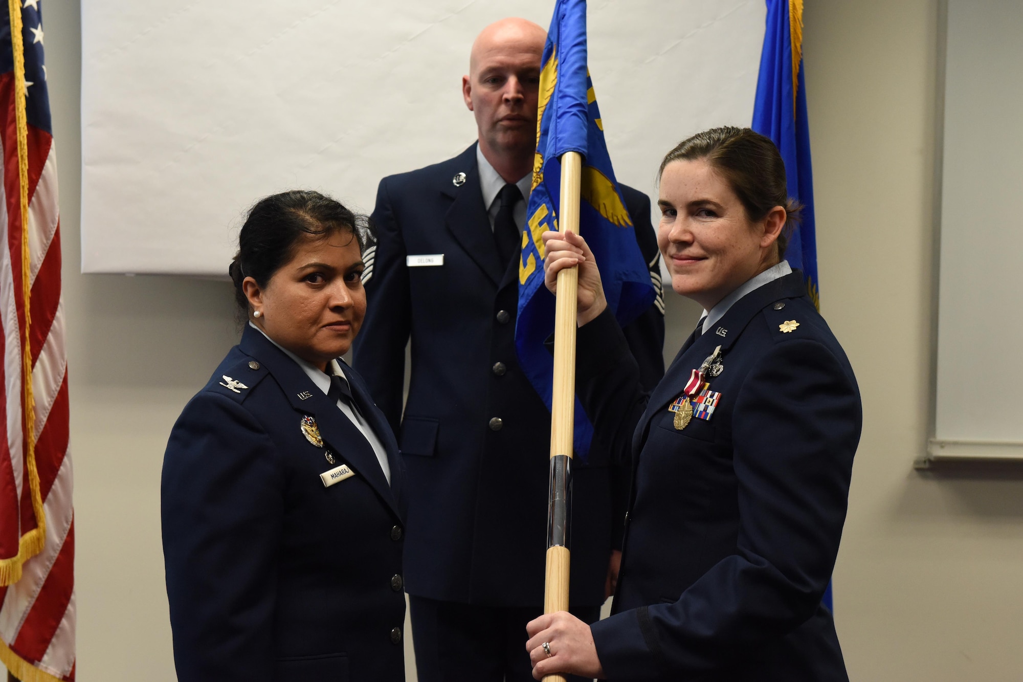 Maj. Maureen A. Downen, the 911th Civil Engineer Squadron commander, poses with the 911 CES guidon, during an assumption of command ceremony at the Pittsburgh International Airport Air Reserve Station, February 11, 2017. Colonel Beena N. Maharaj, 911th Mission Support Group commander presided over the ceremony and welcomed Downen as the new 911 CES commander. Maharaj recognized Downen for her excellent reputation in the civil engineer community, known for her flawless duty performance and ability to get things done. Maj Downen comes to the 911th Airlift Wing with 12 years of active duty experience, having won several Major Command level awards, and reserve expertise from two bases. (U.S. Air Force photo by Tech. Sgt. Jonathan Hehnly)