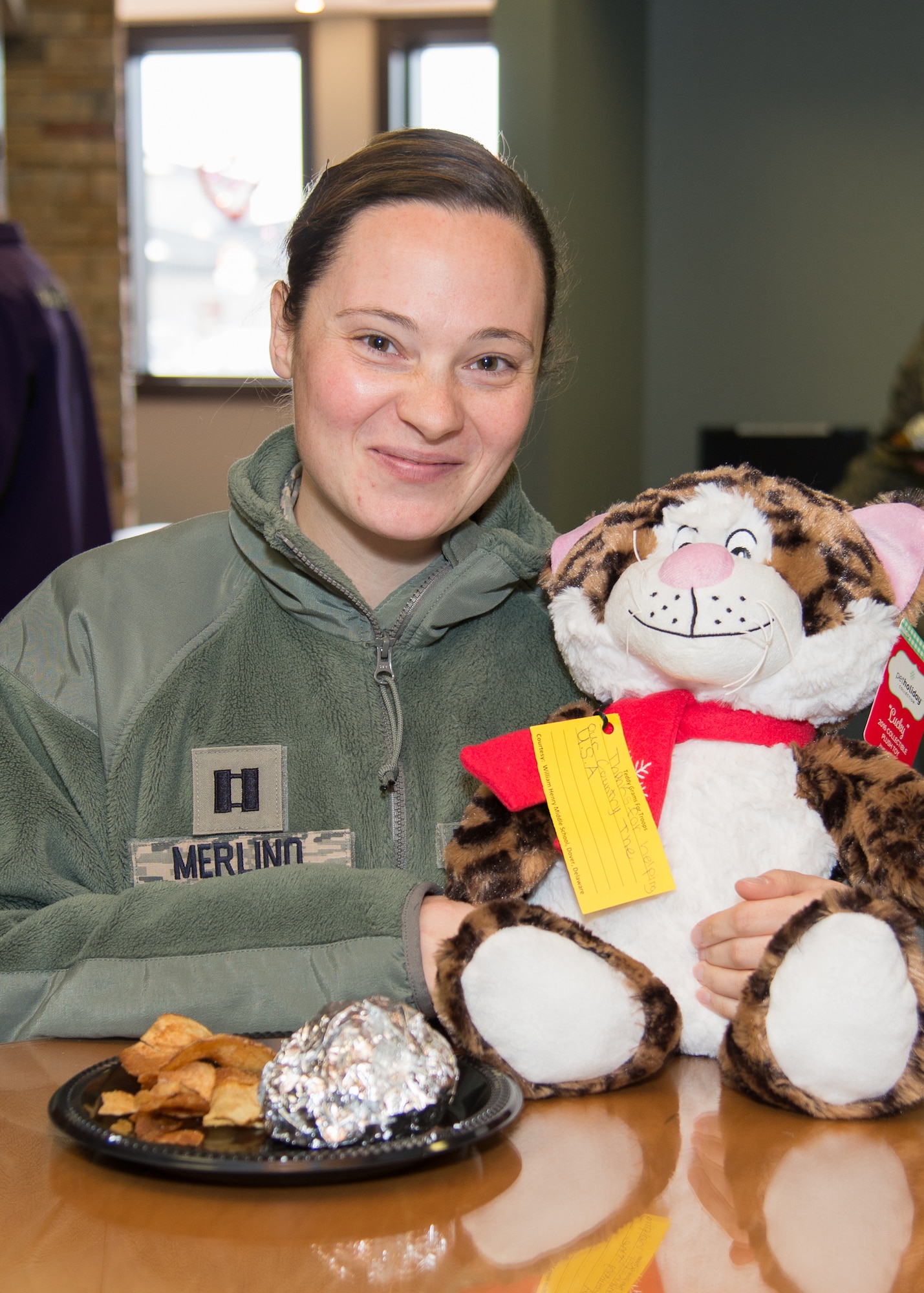 Capt. Brittney Merlino, Community Services Directorate special victim’s counsel, enjoys a meal at the Teddy-Grams for Troops event Feb. 10, 2017, at the USO on Dover Air Force Base, Del. The USO hosted the event with food donated by the Dover Mission BBQ and Teddy-Grams donated by the Delaware State Police and community members. (U.S. Air Force photo by Mauricio Campino)