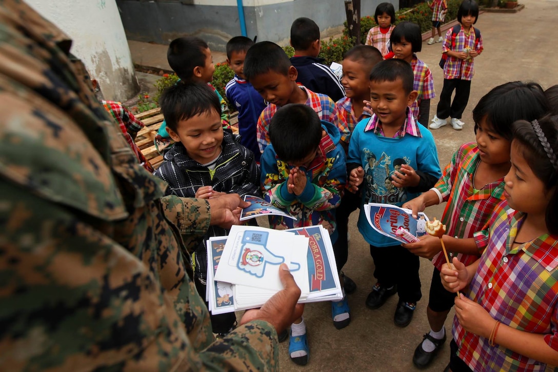 Students receive Cobra Gold stickers and coloring books from service members at Ban Nong Mee, Buri Ram Province, Thailand, during exercise Cobra Gold, Feb. 3, 2017. Marine Corps photo by Lance Cpl. Maximiliano Rosas