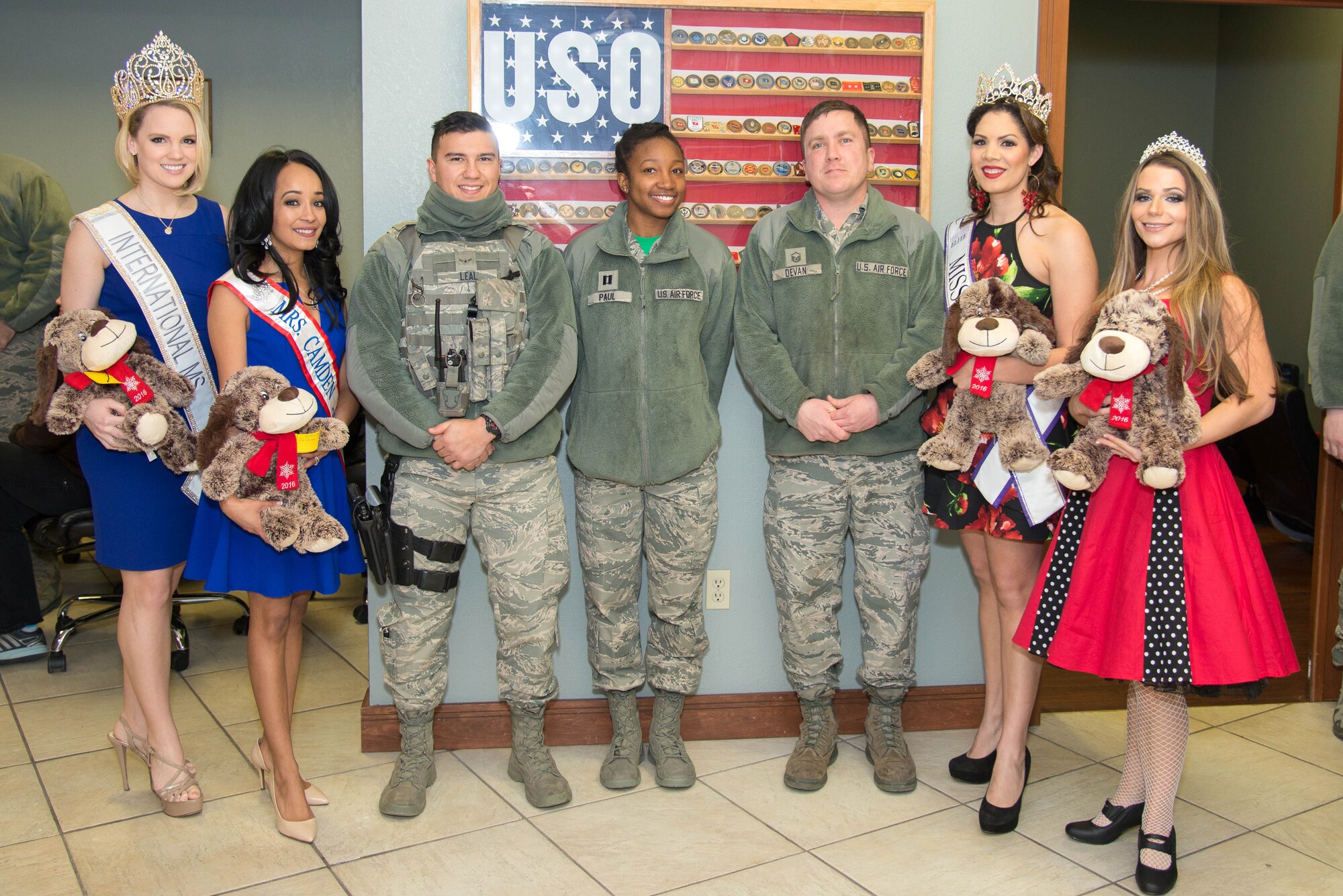 Beauty queens meet Team Dover Airmen at the Teddy-Grams for Troops event Feb. 10, 2017, at the USO on Dover Air Force Base, Del. From left to right are Rose Buckley, International Ms. 2017; Kimberly Phillips, Mrs. Camden Delaware America 2017; Airman Vincent Leal, 436th Security Forces Squadron flight operations journeyman; Capt. Jasmine Paul, 436th Comptroller Squadron Financial Services Flight commander; Master Sgt. David Devan, 436th Security Forces Squadron commercial vehicle inspection gate NCO in charge; Elysa Acosta-Millan, Elite Miss Delaware 2017, and Elissa Troise-Greco, Mrs. Lewes Delaware America 2017. (U.S. Air Force photo by Mauricio Campino)