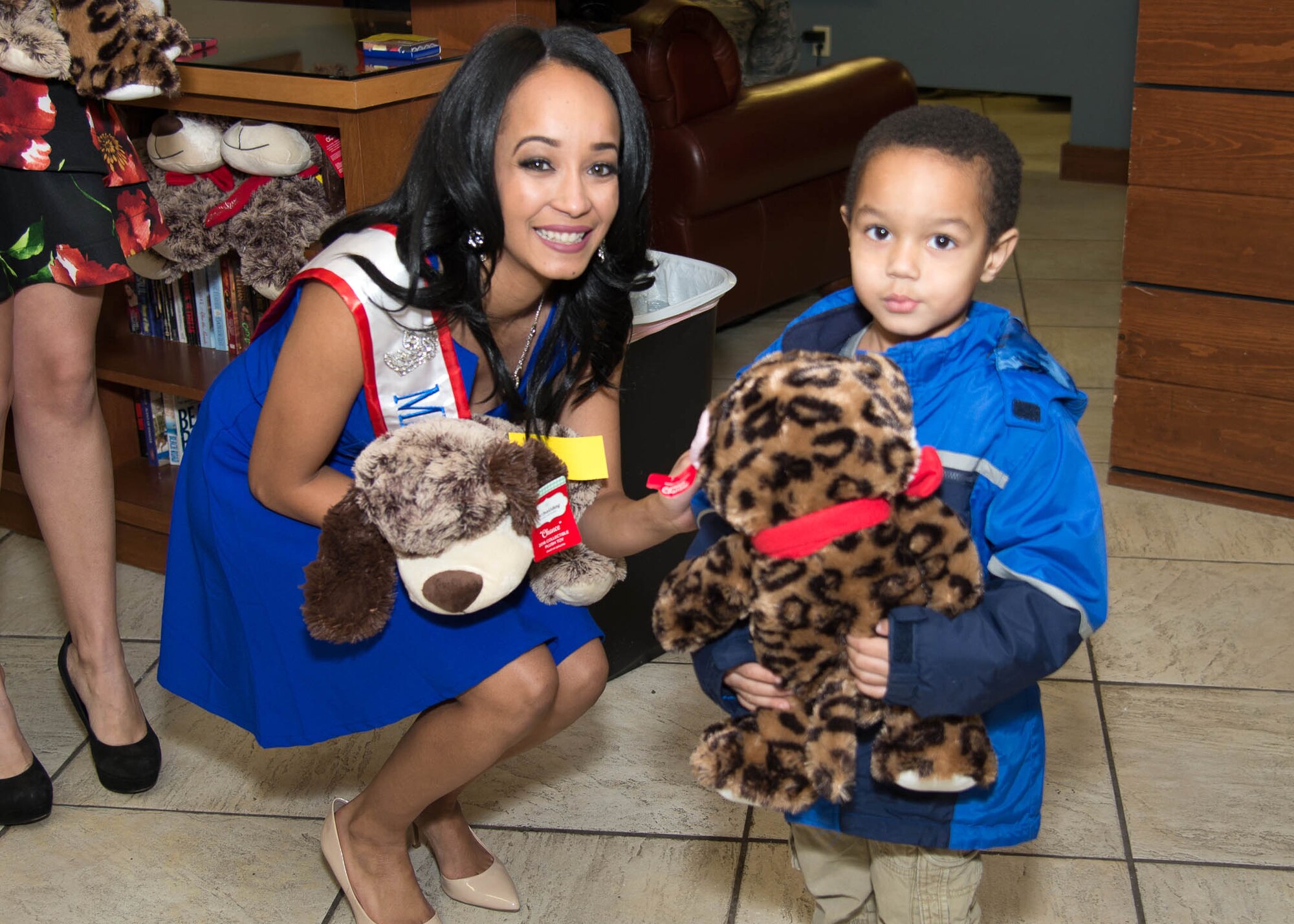 Kimberly Phillips, Mrs. Camden Delaware America 2017, hands out teddy bears at the Teddy-Grams for Troops event Feb. 10, 2017, at the USO on Dover Air Force Base, Del. A total of 155 teddy bears were donated by the Delaware State Police and community members to be distributed to local troops and their families. (U.S. Air Force photo by Mauricio Campino)