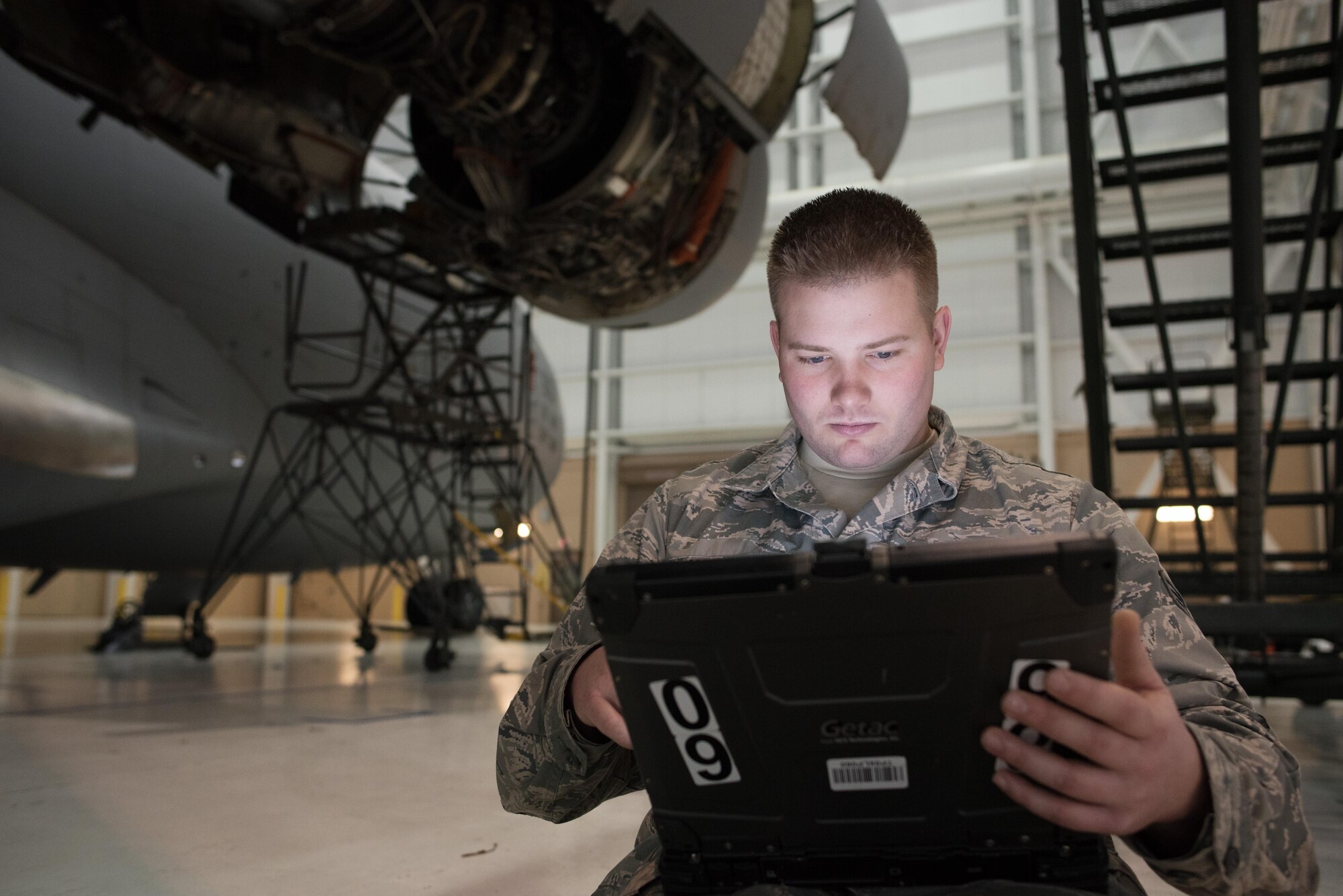 Senior Airman Geoff Hayes (left), 945th Aircraft Maintenance Squadron guidance and control specialist, reviews a technical order for replacing C-17 Globemaster III engine panels, at Travis Air Force Base, Calif. Hayes and a crew of Citizen Airmen worked together Feb. 10, 2017 during Wrench Week, which offers reservists opportunities to reinforce and build their primary job skills. (U.S. Air Force photo by Ken Wright)