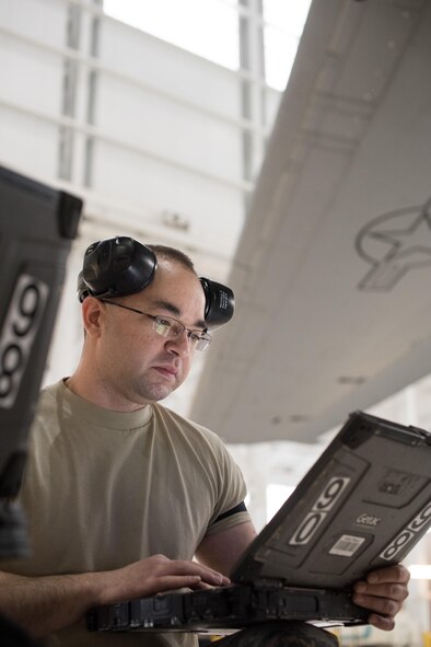 Senior Airman Brandon Mayfield (right), 945th Aircraft Maintenance Squadron crew chief, reviews a technical order for replacing C-17 Globemaster III engine panels, at Travis Air Force Base, Calif. Mayfield and Senior Airman Geoff Hayes (left), 945th AMXS guidance and control specialist, and Staff Sgt. Simon Nunez (center), 945th AMXS crew chief, worked together Feb. 10, 2017 during Wrench Week, which offers Citizen Airmen opportunities to reinforce and build their primary job skills. (U.S. Air Force photo by Ken Wright)