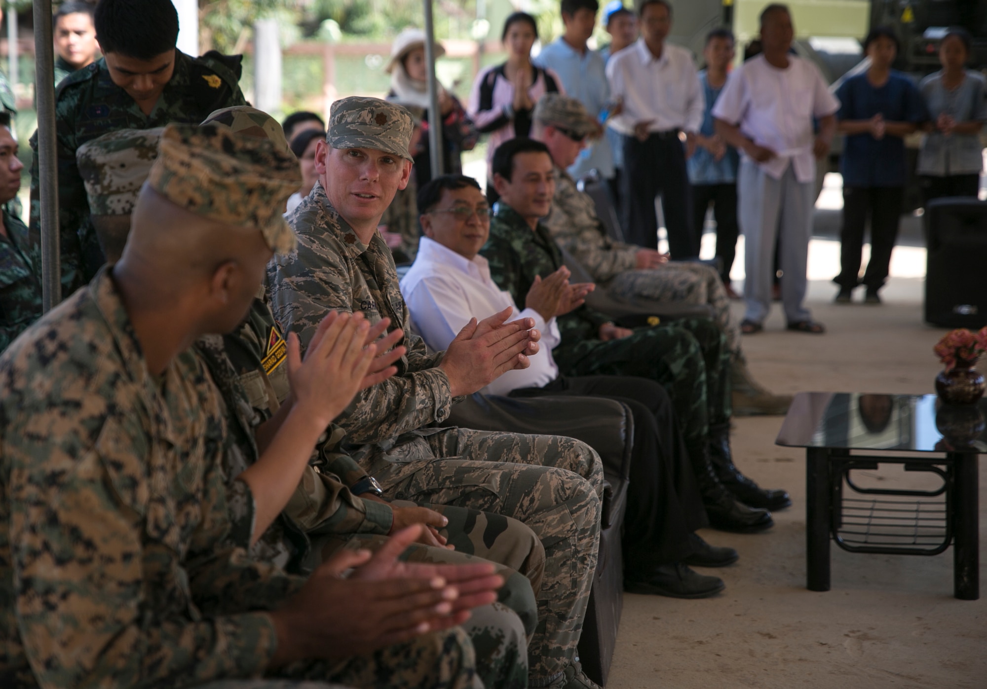 U.S. Air Force Maj. Jack Carroll with the 647th Logistics Readiness Squadron, gives a round of applause during a pillar-raising ceremony at Ban Non Lueam School in Korat Province, Thailand, Jan. 27, 2017. Carroll, a native of Grandview, Texas, is a logistics liaison non-commissioned officer while supporting COBRA GOLD 17 (CG17). The U.S. Air Force worked alongside the Royal Thai Army, Indian Army and China’s People’s Liberation Army to begin building a multi-purpose room for the Ban Non Lueam School, which will improve the quality of life of civilian residents in the area. CG17 demonstrates the commitment of the Kingdom of Thailand and the U.S. to our long-standing alliance and regional partnership toward advancing prosperity and security in the Indo-Asia-Pacific region.  (U.S. Marine Corps photo by Sgt. Ally Beiswanger)