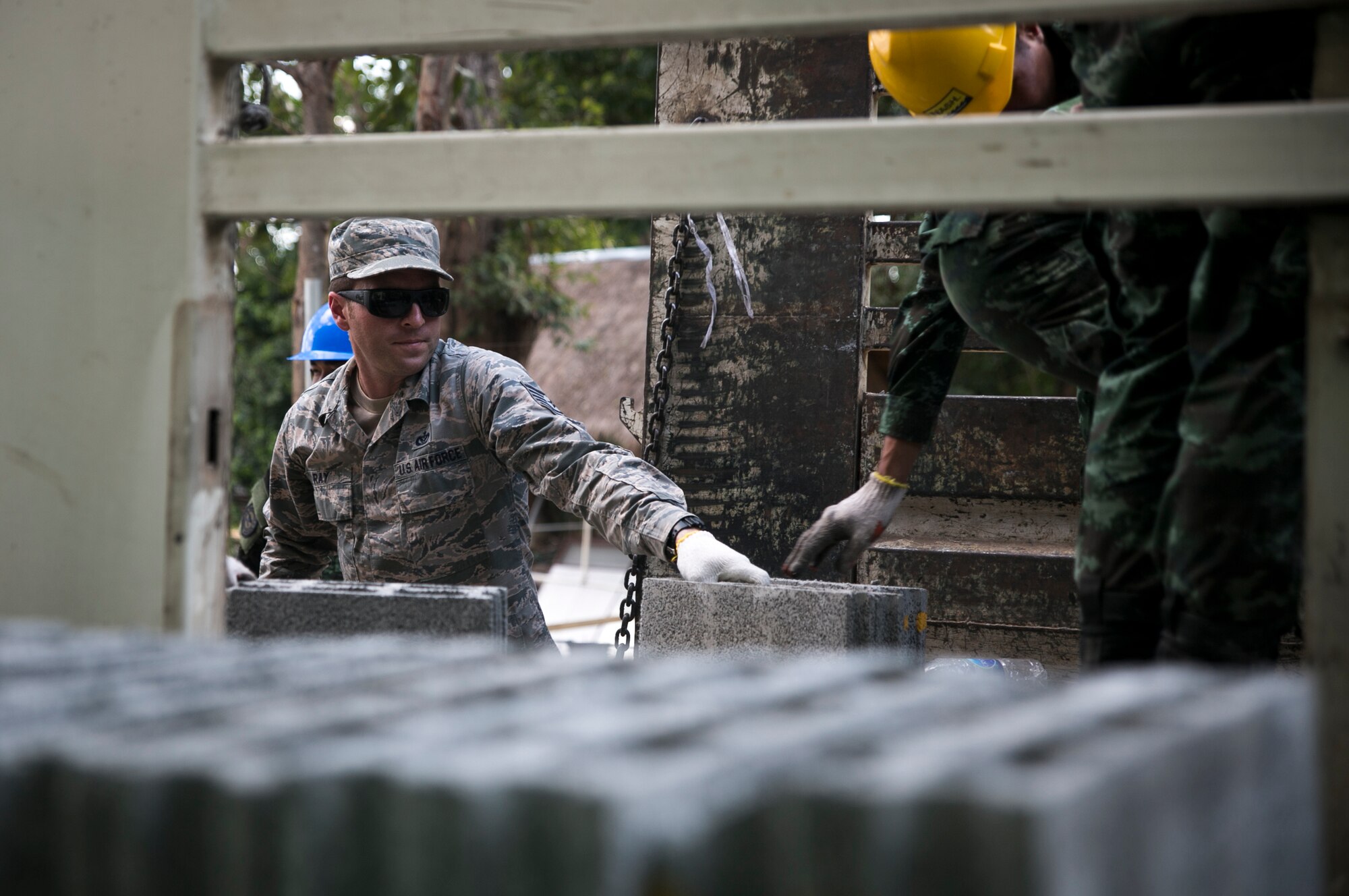 U.S. Air Force Tech Sgt. Daniel Ray, assigned to the 35th Civil Engineering Squadron, moves cinder blocks with soldiers of the Royal Thai Army at Ban Non Lueam School in Korat Province, Thailand, in support of COBRA GOLD 17 (CG17), Jan. 27, 2017. CG17, in its 36th iteration, maintains a consistent focus on Humanitarian Civic Action, community engagement, and medical activities conducted during the exercise to support the needs and humanitarian interests of civilian populations around the region.  (U.S. Marine Corps photo by Sgt. Ally Beiswanger)