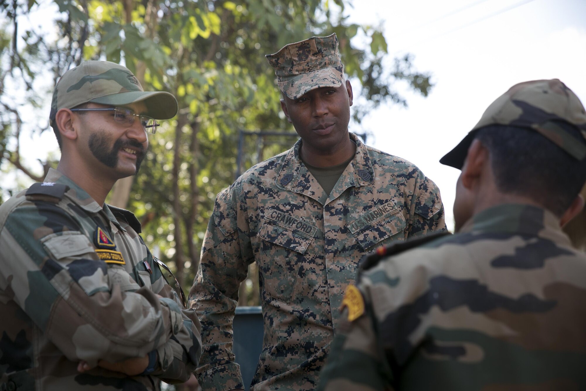 U.S Marine Corps Master Sgt. Corey Crawford with Marine Wing Support Squadron 172, 1st Marine Air Wing, III Marine Expeditionary Force, speaks with leaders of the Indian Army at the Ban Non Lueam School in Korat Province, Thailand, Jan. 27, 2017. Crawford, a native of Lovejoy, Ill., is the staff non-commissioned officer in charge of the Coalition Joint Civil-Military Operations Task Force while supporting COBRA GOLD 17 (CG17). CG17 demonstrates the commitment of the Kingdom of Thailand and the U.S. to our long-standing alliance and regional partnership toward advancing prosperity and security in the Indo-Asia-Pacific region.  (U.S. Marine Corps photo by Sgt. Ally Beiswanger)