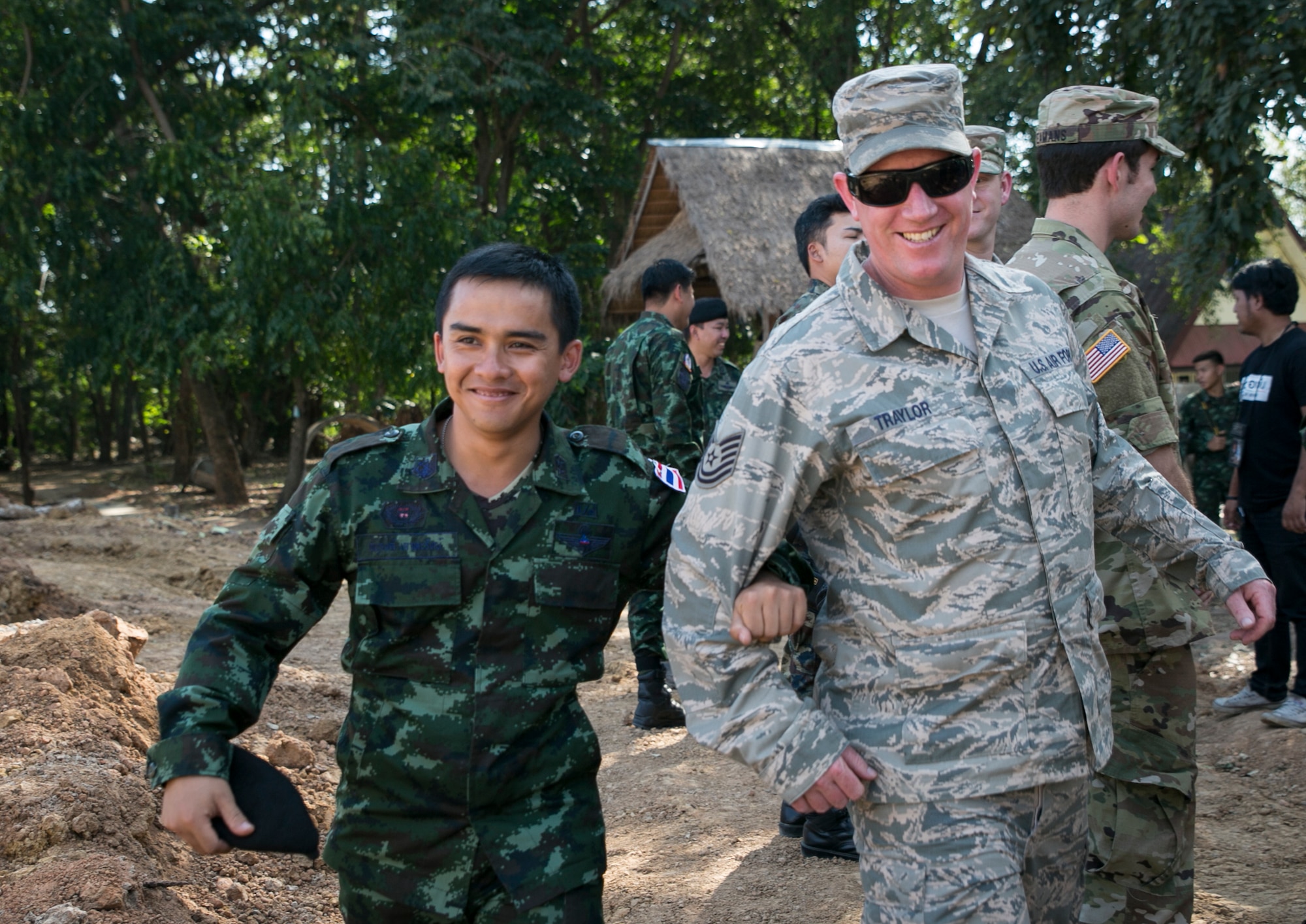 A soldier from the Royal Thai Army takes U.S Air Force Tech Sgt. Glen Traylor to a meet-and-greet area with foreign leaders at Ban Non Lueam School in Korat Province, Thailand, Jan. 27, 2017. Traylor, a native of Santa Rosa, Calif., is the non-commissioned officer in charge of this site while supporting COBRA GOLD 17 (CG17). CG17 is the largest Theater Security Cooperation exercise in the Indo-Asia-Pacific region and is an integral part of the U.S. commitment to strengthen engagement in the region.  (U.S. Marine Corps photo by Sgt. Ally Beiswanger)