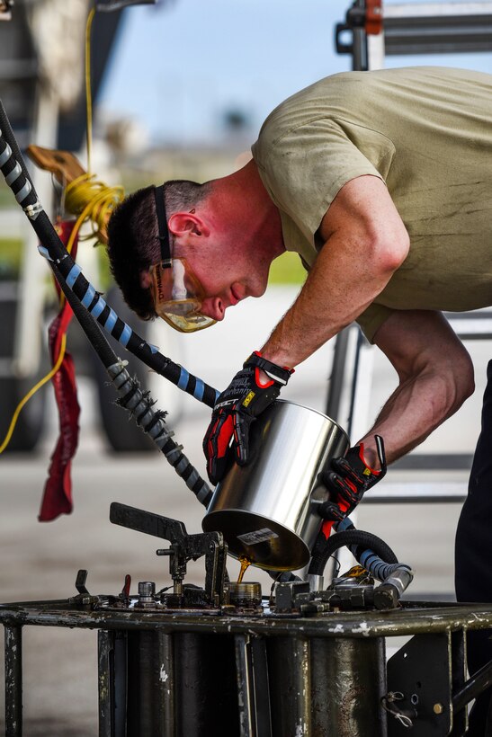 Air Force Senior Airman Cameron Hylan pours oil for an engine on a B-1B Lancer at Andersen Air Force Base, Guam, Feb. 6, 2017. Hylan is assigned to the 36th Expeditionary Aircraft Maintenance Squadron. Air Force photo by Tech. Sgt. Richard P. Ebensberger