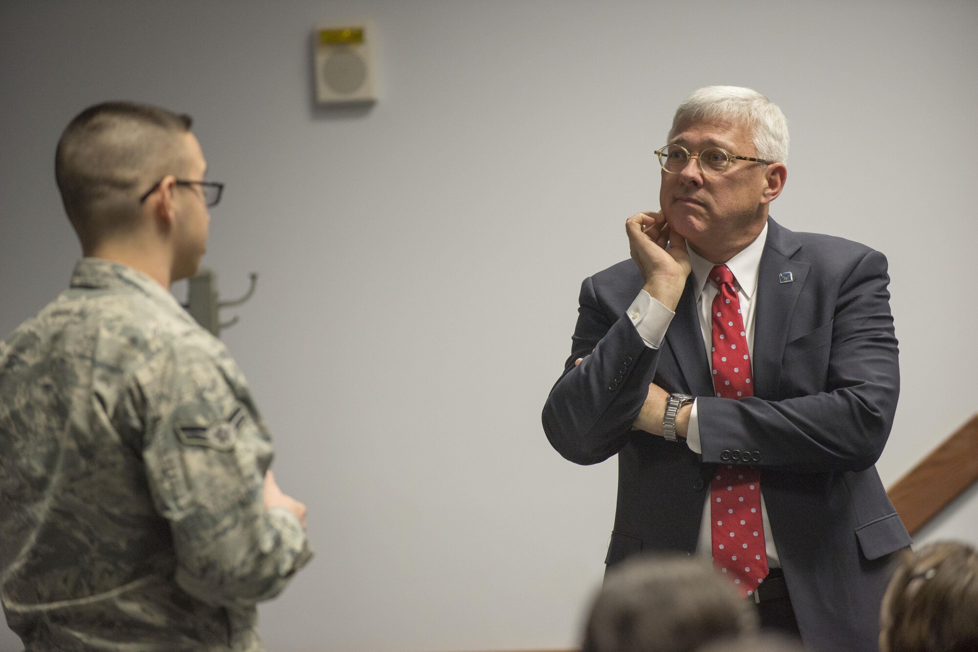 Daniel Sitterly, Principal Deputy Assistant Secretary of the Air Force for Manpower and Reserve Affairs, listens to Airman 1st Class Justin Schindlbeck, 436th Comptroller Squadron financial services technician, during his visit Feb. 3, 2017, on Dover Air Force Base, Del. Sitterly was invited to speak at the 2016 436th Airlift Wing Annual Awards Ceremony which happened later that night. (U.S. Air Force photo by Staff Sgt. Jared Duhon)