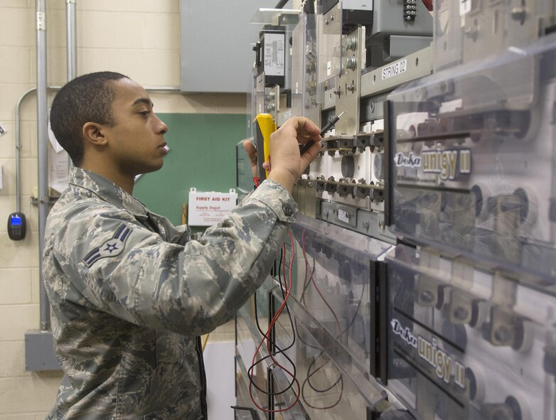 Airman 1st Class Nicklaus Norman, 88th Communications Squadron Telephone Repair Shop voice network system technician, checks the voltage produced by a battery in his shop’s direct-current power plant, Jan. 27, 2017 at Wright-Patterson Air Force Base, Ohio. The base’s phone system has redundant backup power supplies, including emergency generators and batteries. (U.S. Air Force photo by R.J. Oriez/Released)