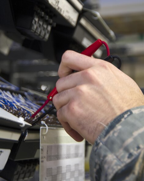 The leads of a test telephone are held to terminals in a line equipment number block, Jan. 27, 2017, in the 88th Communications Squadron Telephone Repair Shop for Area A of Wright-Patterson Air Force Base, Ohio. The 1ineman’s test set was used to check for a dial tone as technicians worked to troubleshoot a problem. (U.S. Air Force photo by R.J. Oriez/Released)