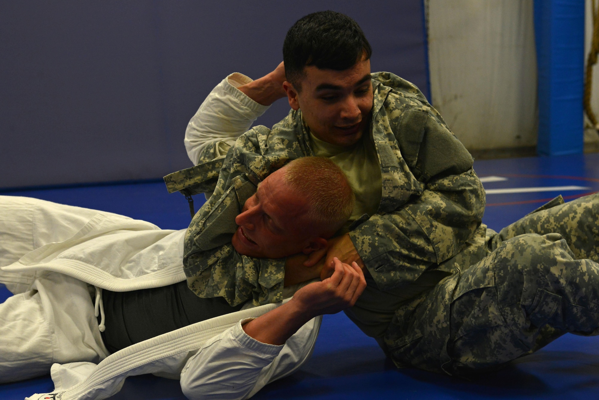 U.S. Army Spc. Matthew Roverso, U.S. Army Central geospatial engineer, puts Sgt. Brandon McClintick, U.S. ARCENT combatives instructor, in a headlock at Shaw Air Force Base, S.C., Feb. 7, 2017. The classes offered at the Combatives House can provide physical and mental health benefits such as increased strength, flexibility and stress relief. (U.S. Air Force photo by Airman 1st Class Destinee Sweeney)