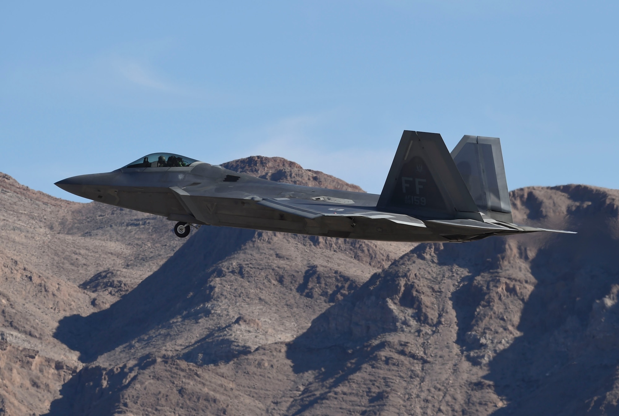 An F-22 Raptor flies over Nellis Air Force Base, Nev., during Red Flag 17-1 Jan. 26, 2017. The Raptor is a multi-role stealth fighter aircraft that not only suppresses its own targets, but provides support for U.S. and coalition fourth-generation aircraft targeting as well. (U.S Air Force photo by Staff Sgt. Natasha Stannard)