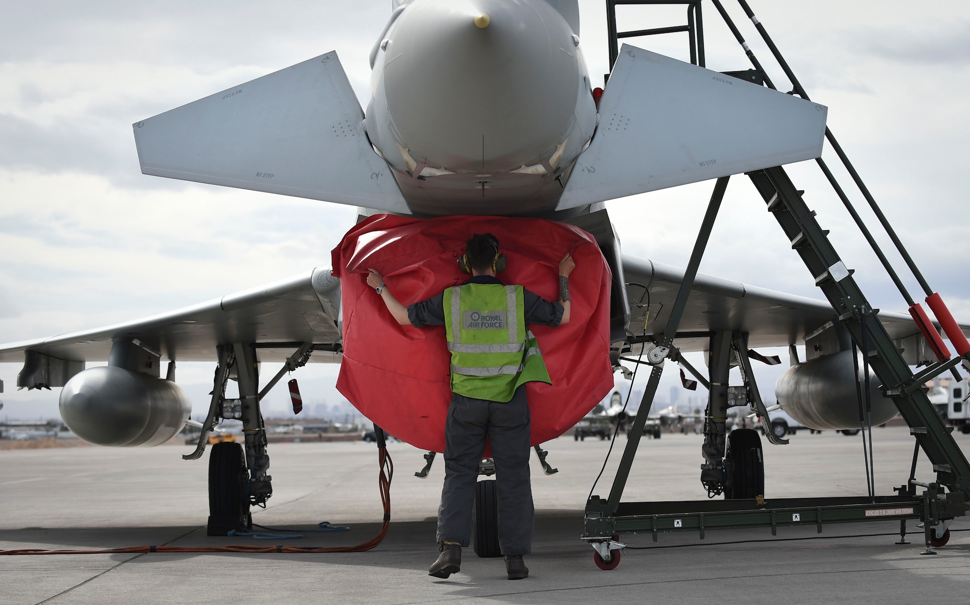 A Royal Air Force Eurofighter Typhoon maintainer uncovers a Typhoon’s intake during Red Flag 17-1 at Nellis Air Force Base, Nev., Feb 7, 2016. The Typhoon is an agile multi-role fighter that has worked with the F-22 Raptor in contingency and training operations, and is now training with both the Raptor and F-35A Lighting II. (U.S Air Force photo by Staff Sgt. Natasha Stannard)