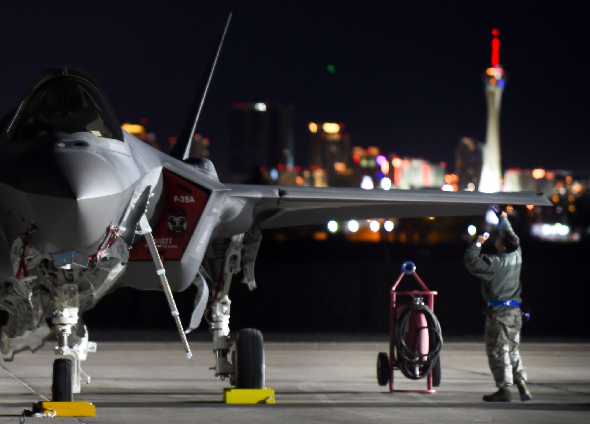 A maintainer with the 388th Fighter Wing out of Hill Air Force Base, Utah, checks for structural damages on an F-35A Lightning II during Red Flag 17-1 at Nellis Air Force Base, Nev., Jan. 25, 2017. For most non-structural and all structural repairs, low observable aircraft structure technicians must either fix the paneling damage or remove paneling for maintainers to repair other issues. (U.S. Air Force photo by Staff Sgt. Natasha Stannard)