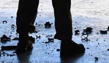 Pieces of radar absorbent material from an F-22 Raptor fall to the floor during Red Flag 17-1 at Nellis Air Force Base, Nev., Feb. 3, 2017. The material was hammered away to allow for repairs to a light panel it was surrounding. (U.S. Air Force photo by Staff Sgt. Natasha Stannard)