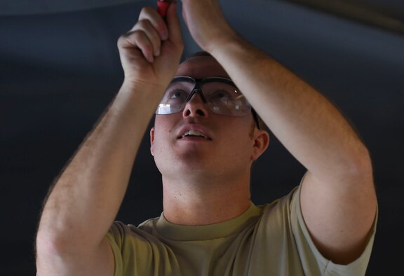 U.S. Air Force Staff Sgt. Zachary Dunn, 192nd Fighter Wing low observable aircraft structures technician, removes radar absorbent material from an F-22 Raptor during Red Flag 17-1 at Nellis Air Force Base, Nev., Feb. 3, 2017. Pilot’s missions at Red Flag depend on LO enabled partly by the radar absorbent material. (U.S. Air Force photo by Staff Sgt. Natasha Stannard)