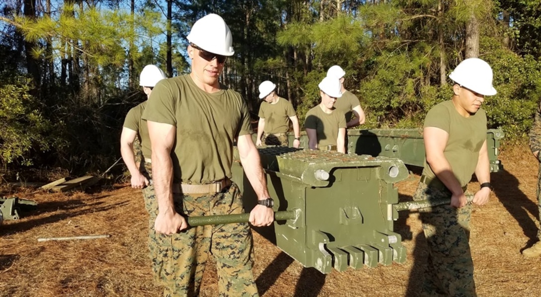 On February 8, 2017, Marines attached to Combat Engineer Officer course 2-17 (CEO 2-17) remove a top panel from the Medium Girder Bridge after retrieving the bridge out of the gap. During their period of instruction, CEO students learn how to plan for and construct a Medium Girder Bridge.  Pictured from left to right:  Second Lieutenants Mitch Bottini, Kerri Hands, and Manuel Ramirez.

