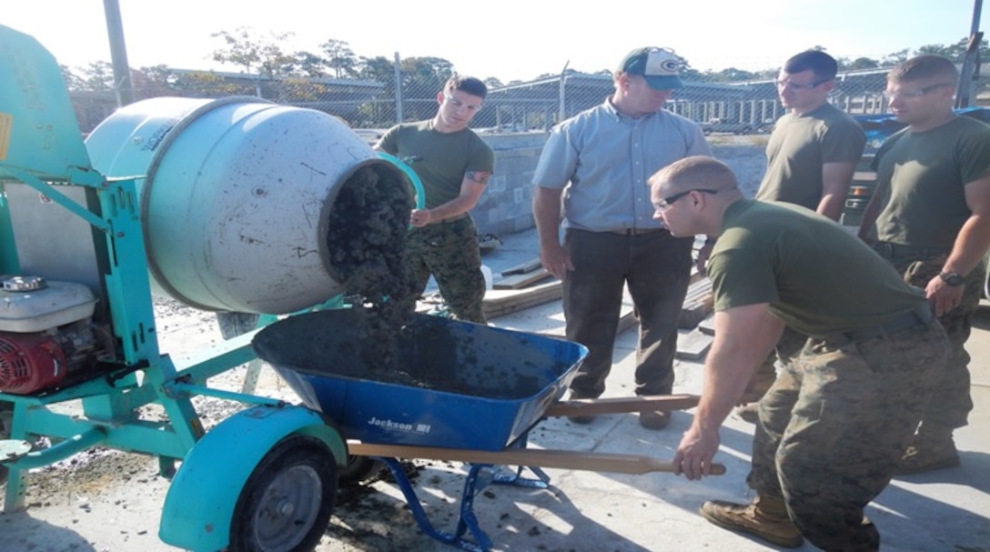 On October 28, 2016 Marines attached to Combat Engineer Officer course 1-17 (CEO 1-17) learn how to operate a concrete mixer to mix and pour concrete. Engineers need to calculate the right mixture proportions of sand, gravel, cement, and water in order to produce strong and durable concrete. Pictured from left to right:  Second Lieutenant Kameron Olsen, Mr. Eric Schnitzler, Second Lieutenants William Burton, Jonathan Neltner, and Jacob Petersen.

