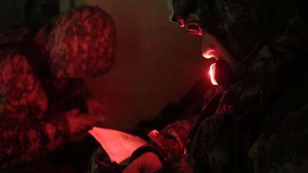 U.S. Army Sergeant 1st Class Corey Stevick of the 1-329th, 86th Training Division writes coordinate information for a simulated extraction mission on February 6th, 2017 on Ft. Hunter Liggett, Calif. Stevick competed in the 91st Training Division's Best Warrior Competition that assessed his proficiency in warrior tasks and drills. (U.S. Army photo by Spc. Derek Cummings/Released)