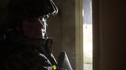 U.S. Army Staff Sgt. Matthew Cassidy of the 2-310th, 86th Training Division guards an open doorway during a simulated extraction mission on February 6th, 2017 on Ft. Hunter Liggett, Calif. Cassidy competed in the 91st Training Division's Best Warrior Competition that assessed his proficiency in warrior tasks and drills. (U.S. Army photo by Spc. Derek Cummings/Released)