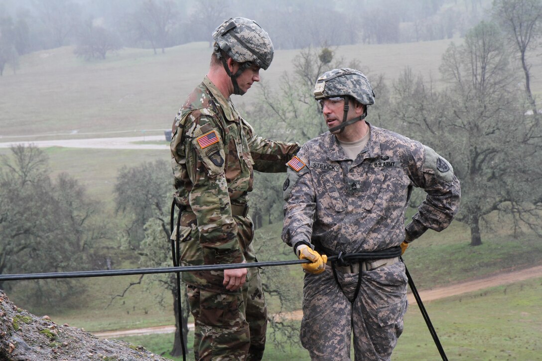 U.S. Army Staff Sgt. Aric Hilmo (left) gives Sgt. 1st Class Corey Stevick of the 1-329th, 86th Training Division instruction before rapelling down a rock face on February 7th, 2017 on Ft. Hunter Liggett, Calif. Stevick participated in the 91st TRaining Division's Best Warrior Competition that assessed soldiers warrior tasks and battle drills. (U.S. Army photo by Spc. Derek Cummings/Released)