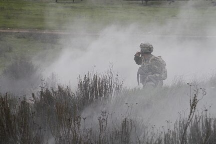 U.S. Army Sgt. Juan Padilla of the 91st Training Division looks to a team member during an engagement in a simulated extraction mission on February 8th, 2017 on Ft. Hunter Liggett, Calif. Soldiers competed in the 91st Training Division's Best Warrior Competition that tested their endurance and knowledge of warrior tasks and drills. (U.S. Army photo by Spc. Derek Cummings/Released)