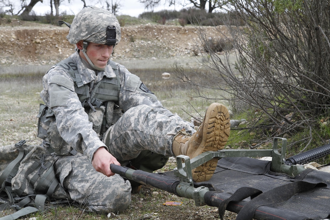 U.S. Army Spc. Jordan Howes of the 2-378th, 91st Training Division opens a litter for the transport of a casualty during a simulated extraction mission on February 8th, 2017 on Ft. Hunter Liggett, Calif. Soldiers competed in the 91st Training Division's Best Warrior Competition that tested their endurance and knowledge of warrior tasks and drills. (U.S. Army photo by Spc. Derek Cummings/Released)